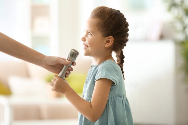 Girl being handed microphone