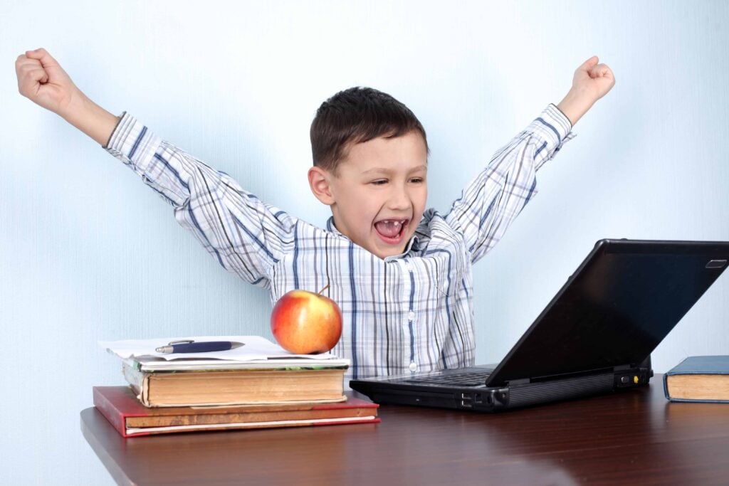 Proud kid working on a computer - Courses and Workshops